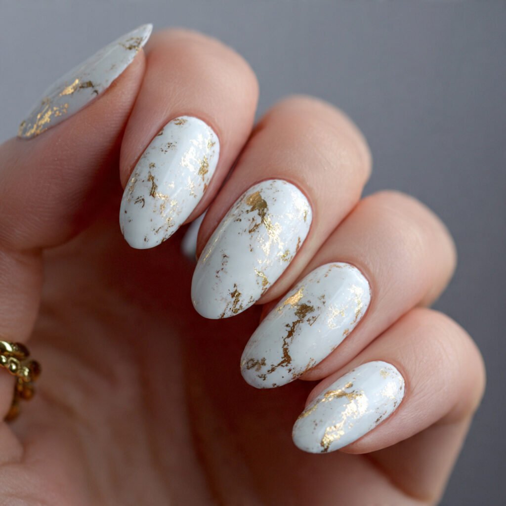 white sand nails with gold foil flecks