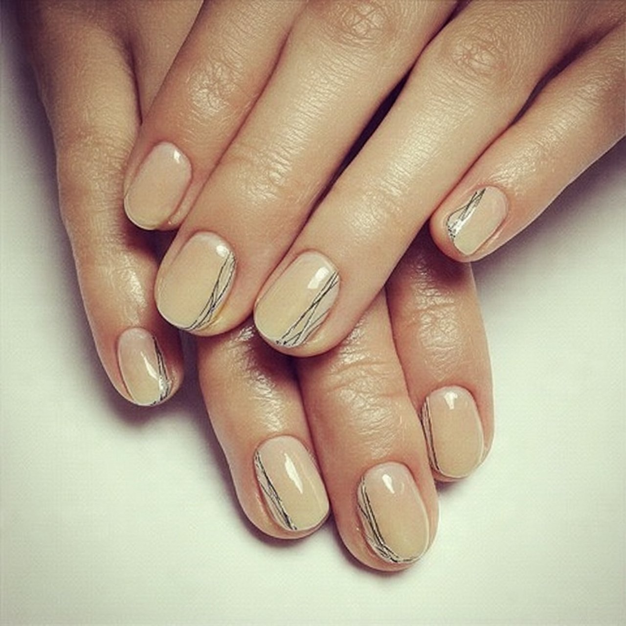 light pink cat eye nails with silver stripes attra