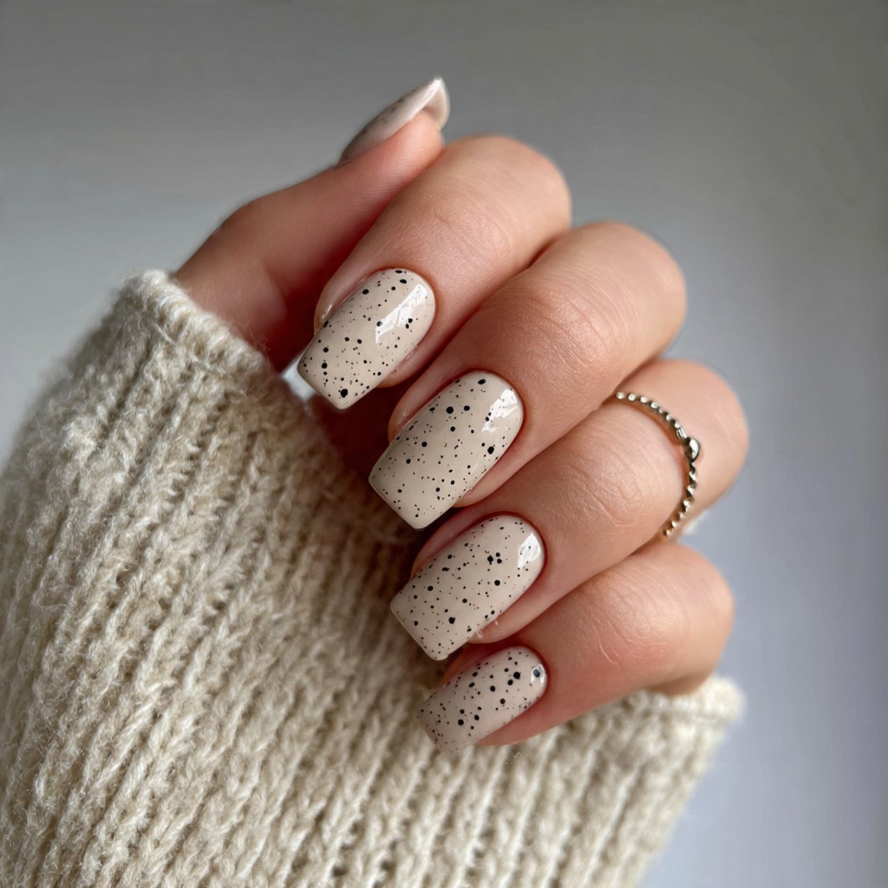 beige nails with black micro dots nails