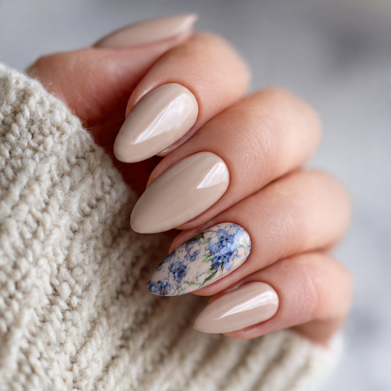 neutral almond nails with one statement art nail a
