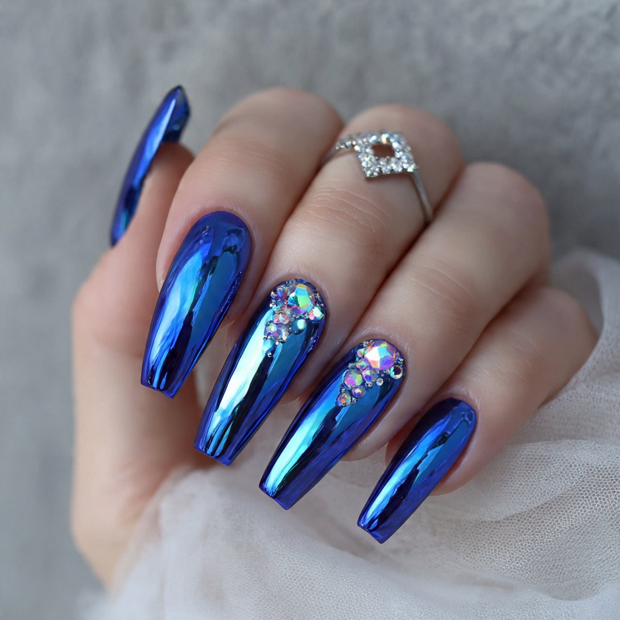 blue chrome nails with tiny crystal details nails