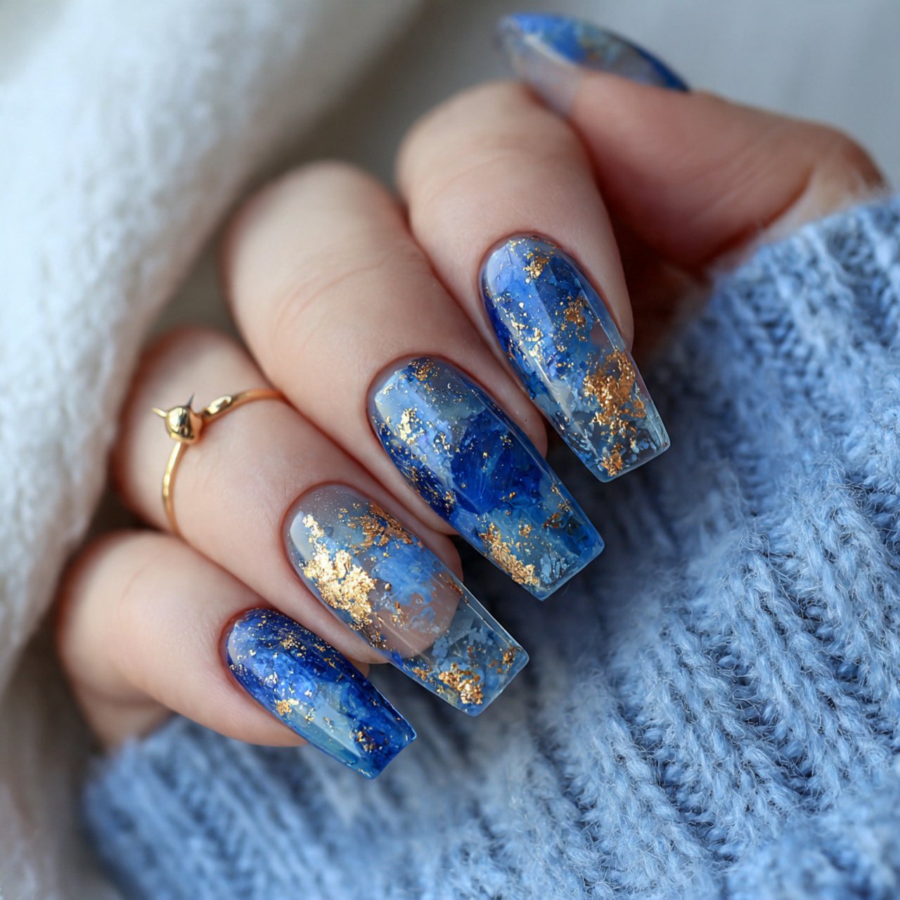 blue jelly nails with suspended gold flakes nails