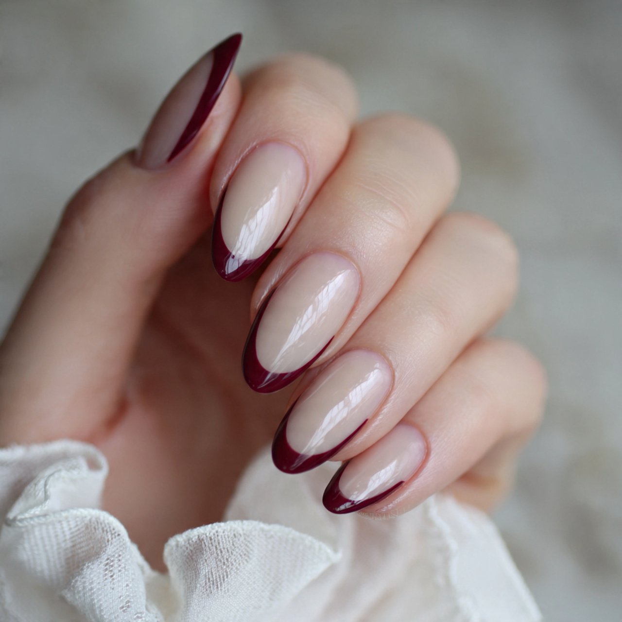 burgundy french tips on a milky almond base nails