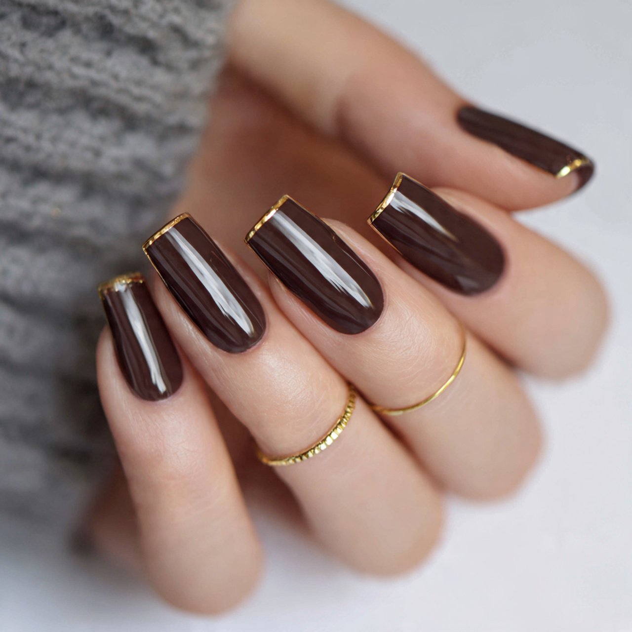 glossy chocolate brown nails with one gold line ac
