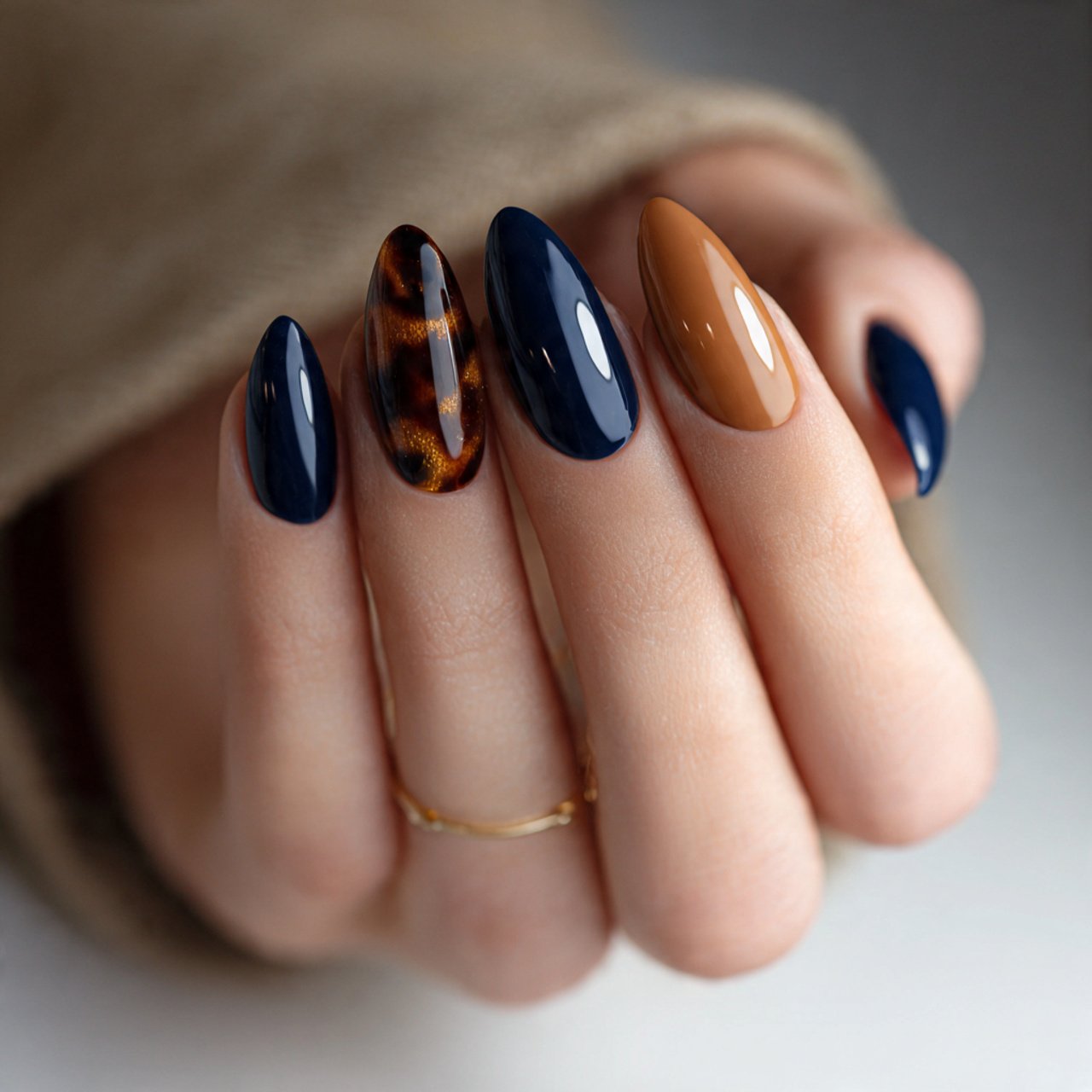 glossy navy and toffee almond nails