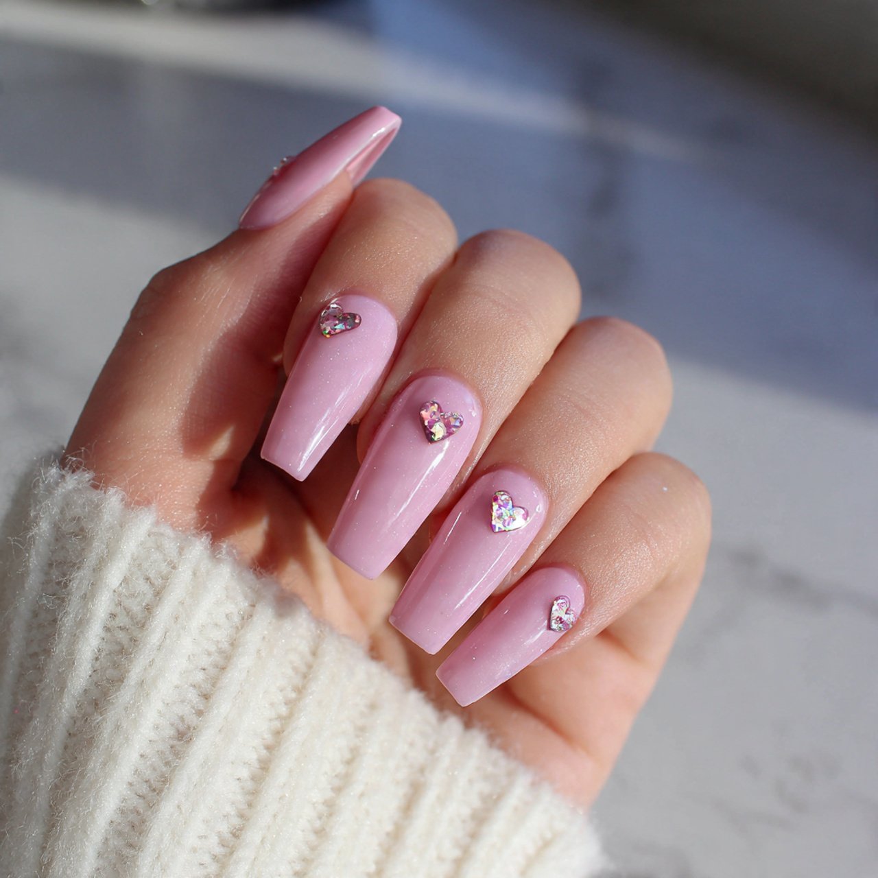 pink acrylic nails with tiny heart accents